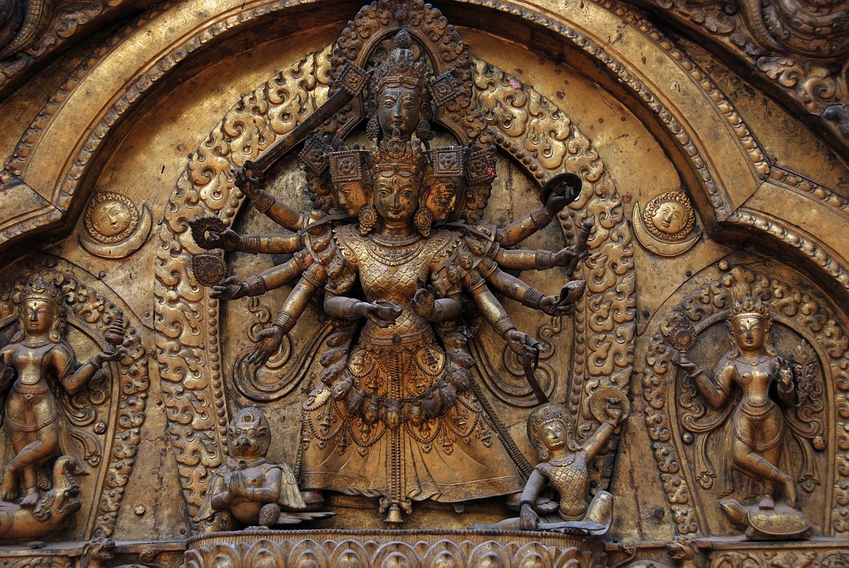 Kathmandu Bhaktapur 04-3 Bhaktapur Durbar Square Golden Gate Torana Taleju Bhawani Close Up Here is a close up of the four-headed and 10-armed figure of the goddess Taleju Bhawani directly above the door of the Golden Gate in Bhaktapur�s Durbar Square. On the left Shri stand on a crocodile; on the right Lakshmi stands on a tortoise.